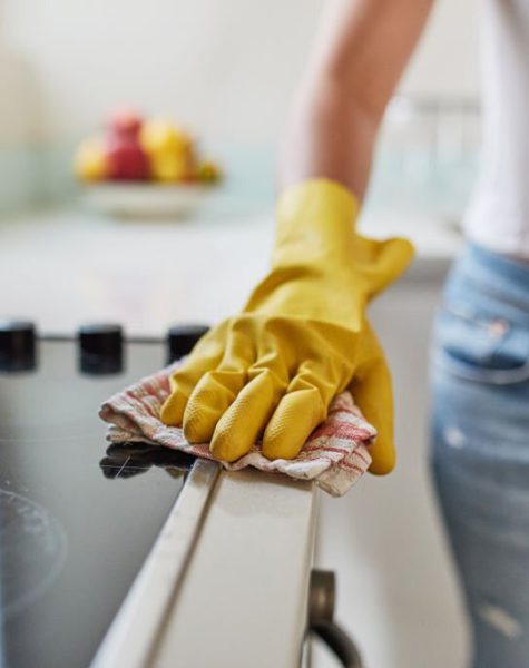 Cropped shot of a woman cleaning a kitchen counter at home